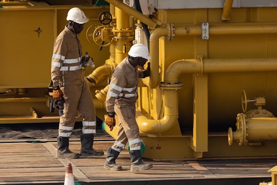 Total Energies employees work on Uganda’s crude oil pipeline. BADRU KATUMBA/AFP via Getty Images